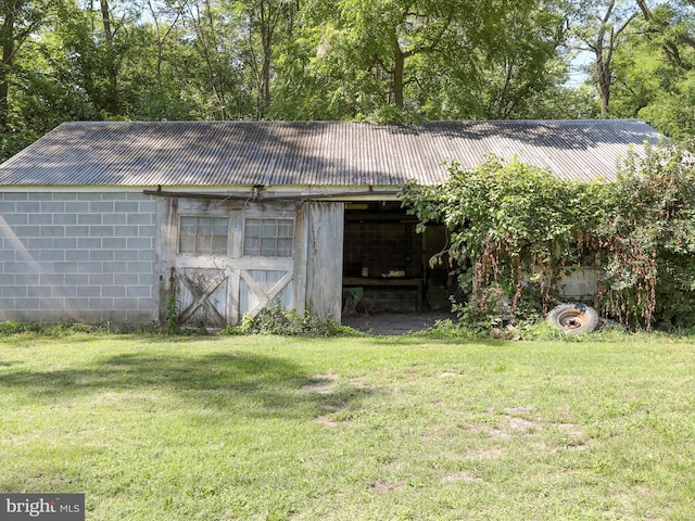 view of outbuilding featuring a yard