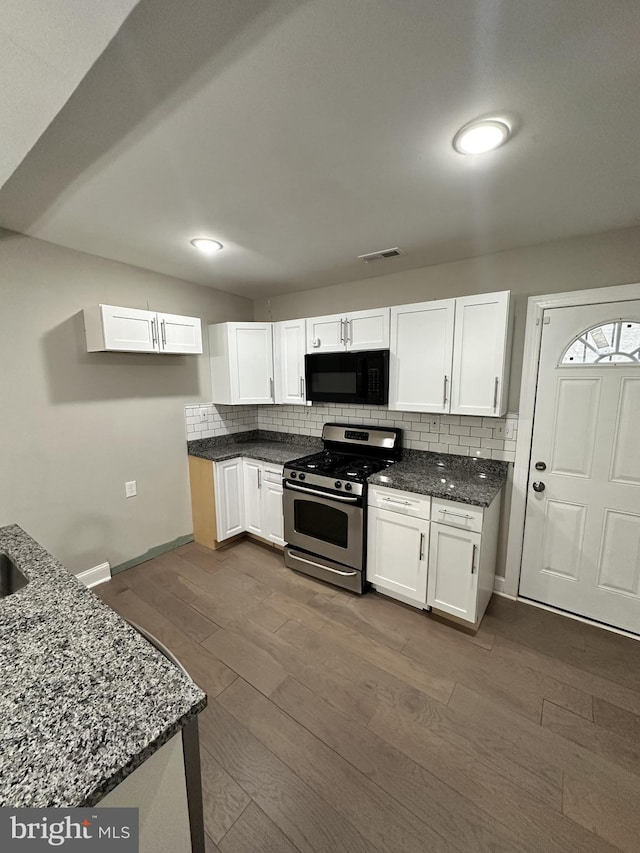 kitchen featuring backsplash, stainless steel range with gas stovetop, dark hardwood / wood-style flooring, and white cabinets