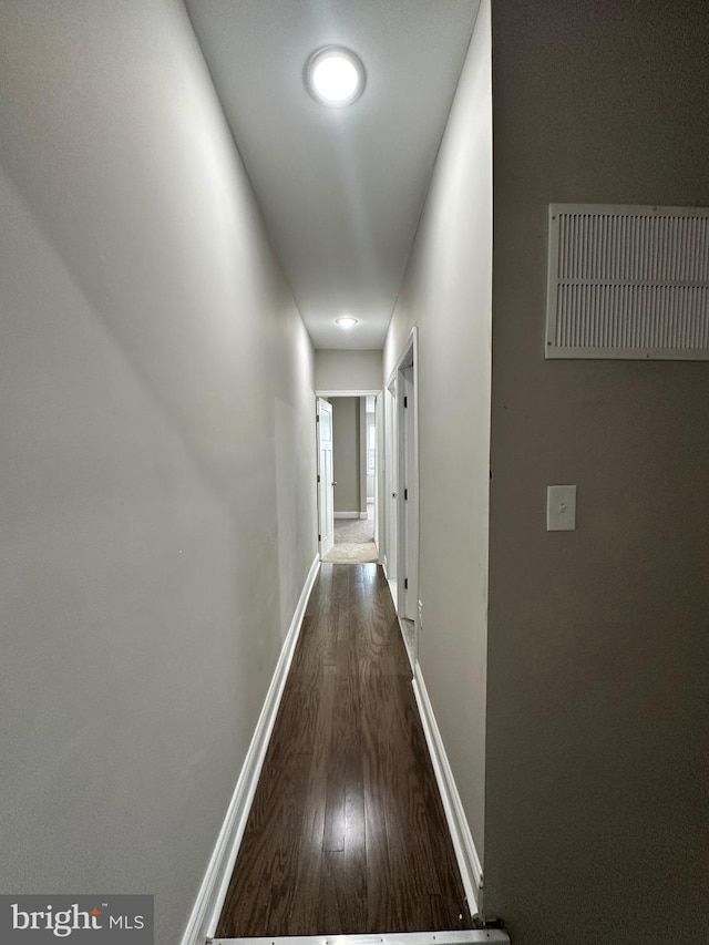 hallway featuring dark hardwood / wood-style flooring