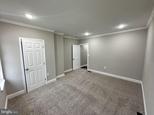 unfurnished bedroom featuring ornamental molding and carpet flooring