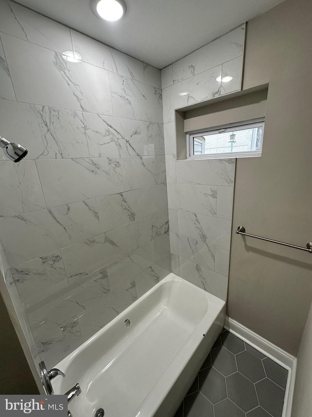 bathroom featuring tiled shower / bath and tile patterned floors