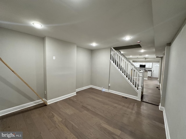 basement with dark hardwood / wood-style flooring