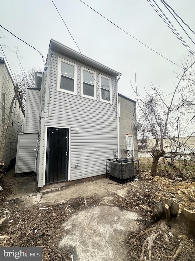 rear view of house featuring central air condition unit