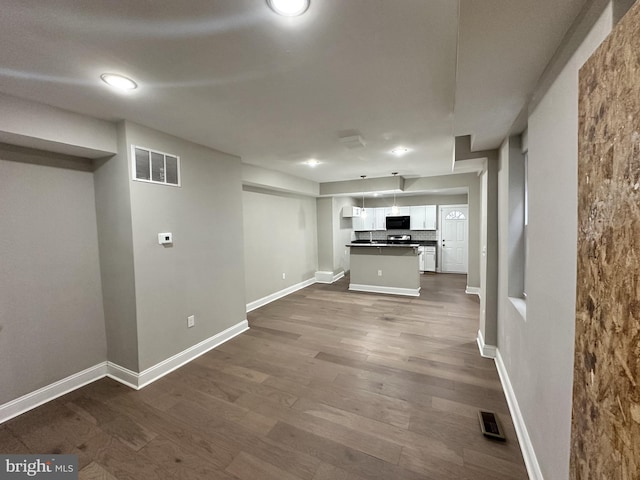 unfurnished living room featuring dark hardwood / wood-style floors