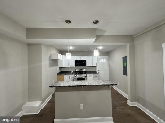 kitchen with white cabinetry, backsplash, gas stove, dark hardwood / wood-style flooring, and decorative light fixtures