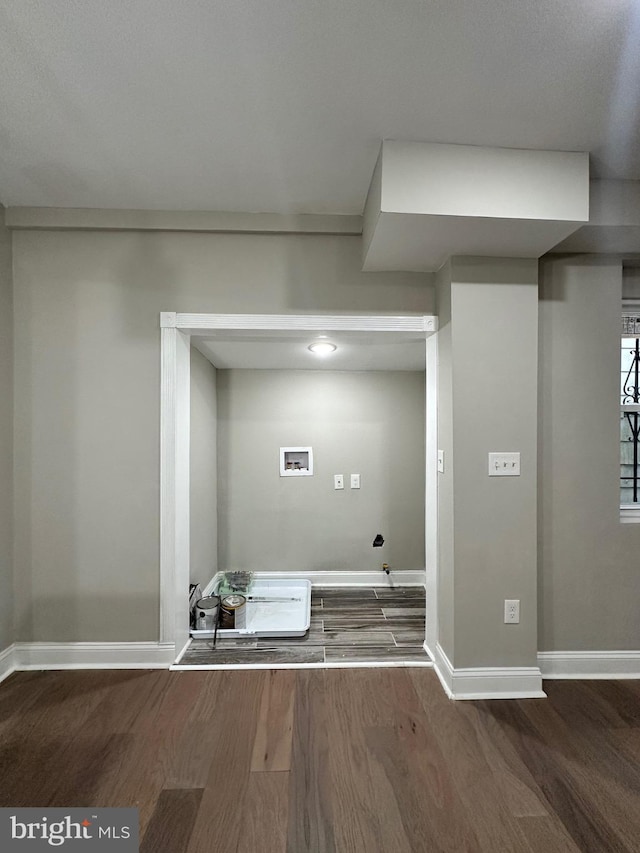 laundry area featuring dark hardwood / wood-style floors and washer hookup