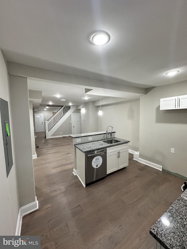 kitchen featuring pendant lighting, sink, white cabinets, a center island with sink, and stainless steel dishwasher