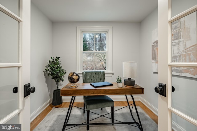 office with light hardwood / wood-style flooring