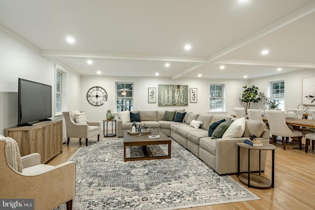 living room with beam ceiling, light hardwood / wood-style floors, and ornamental molding