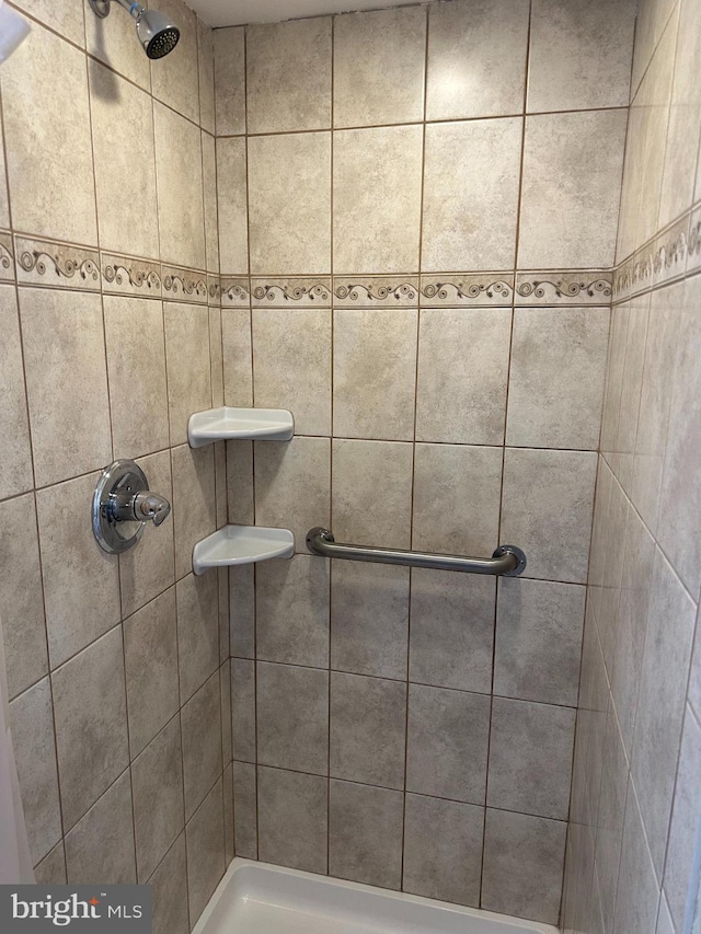 bathroom with tiled shower