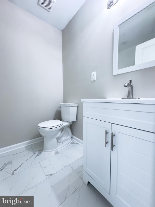 bathroom with vanity and toilet