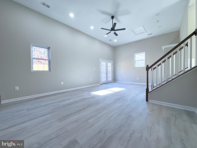 unfurnished living room featuring french doors, light hardwood / wood-style flooring, and ceiling fan