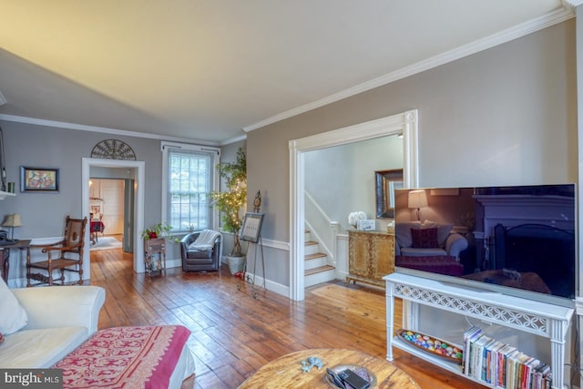 living room with hardwood / wood-style floors and crown molding