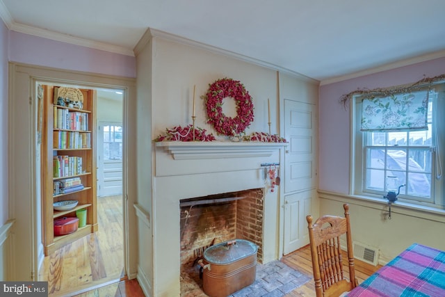 living room featuring light hardwood / wood-style floors and ornamental molding