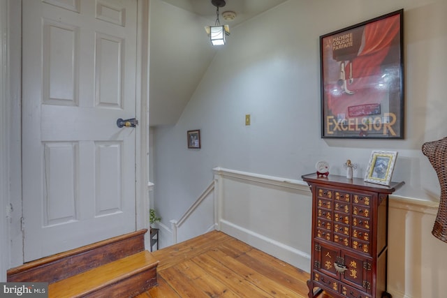 interior space with light hardwood / wood-style floors and vaulted ceiling