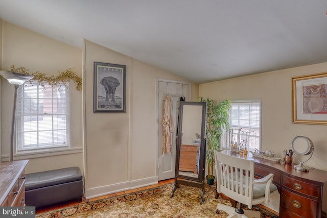 home office featuring light hardwood / wood-style flooring, plenty of natural light, and lofted ceiling