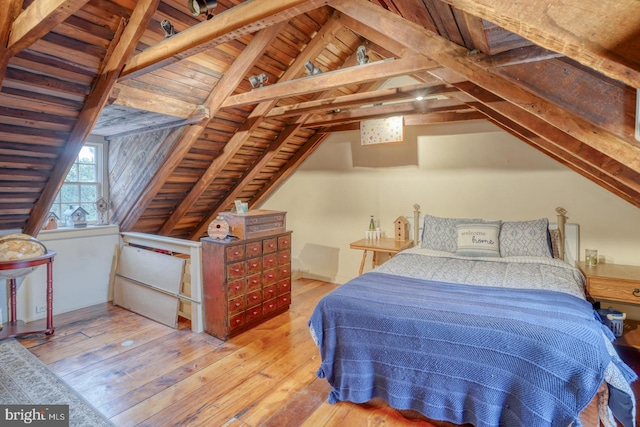 bedroom with hardwood / wood-style floors, lofted ceiling with beams, and wooden ceiling