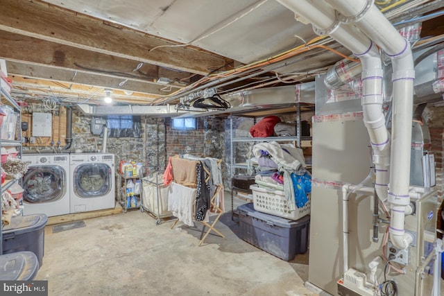 basement with heating unit and washing machine and clothes dryer