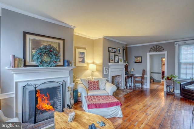 living room featuring wood-type flooring and ornamental molding