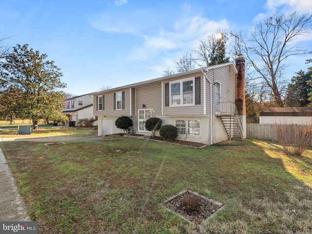 split foyer home with a front yard and a garage