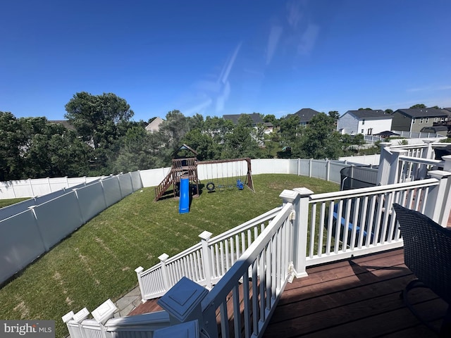 wooden terrace with a lawn and a playground