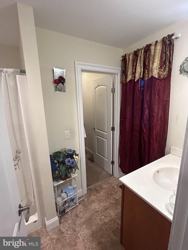 bathroom featuring vanity and curtained shower