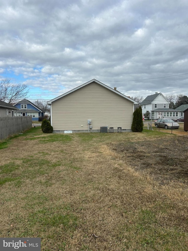 view of side of property with a lawn