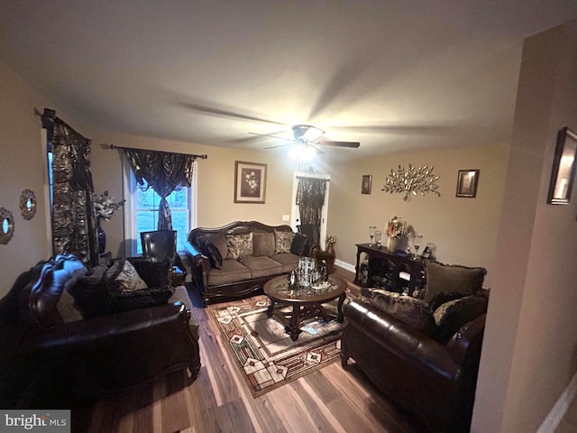 living room featuring hardwood / wood-style flooring and ceiling fan