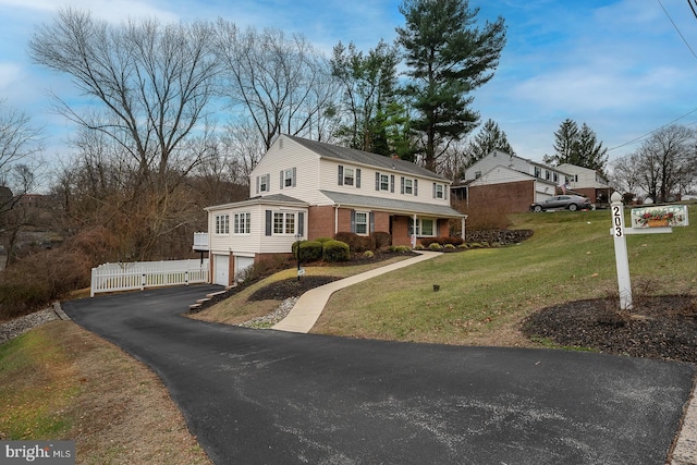 view of front facade with a front yard and a garage