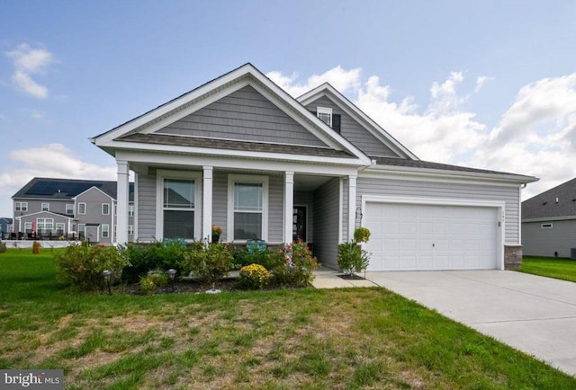 view of front of property featuring a garage and a front lawn