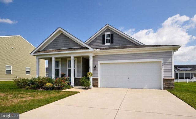 craftsman-style house featuring a front yard and a garage