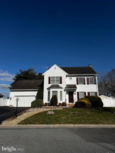 view of front facade with a front yard and a garage