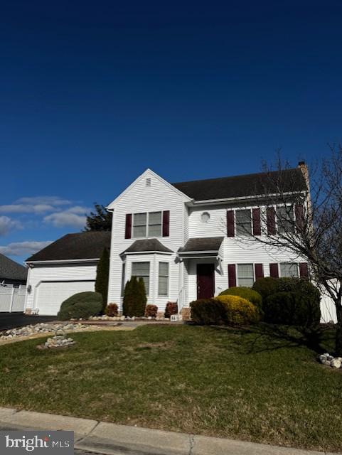 view of front of house with a front lawn and a garage