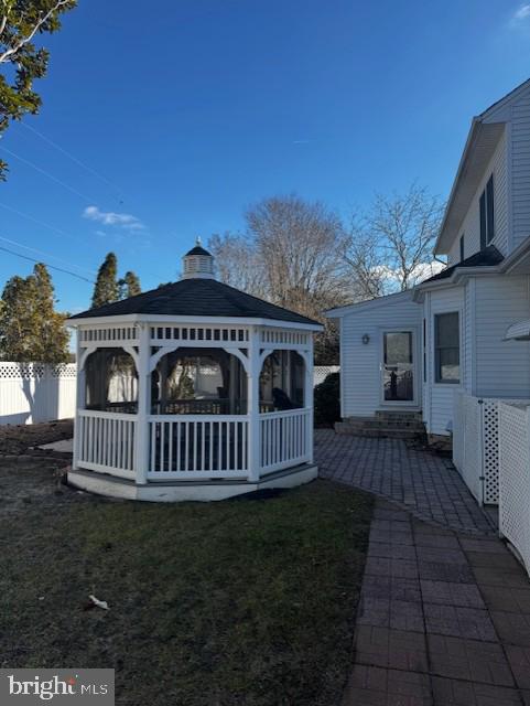 rear view of house with a gazebo and a yard