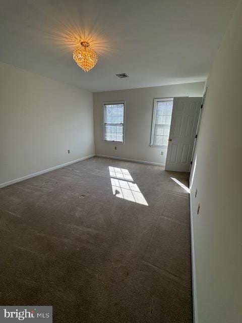 unfurnished room with dark carpet