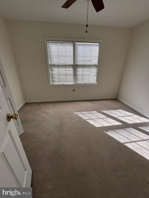 carpeted empty room with ceiling fan