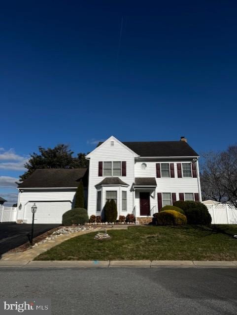 view of front of property featuring a front lawn and a garage