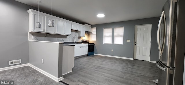 kitchen featuring white cabinets, appliances with stainless steel finishes, decorative backsplash, and sink