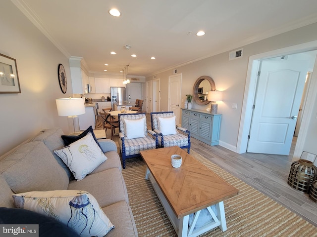 living room with ornamental molding and light wood-type flooring