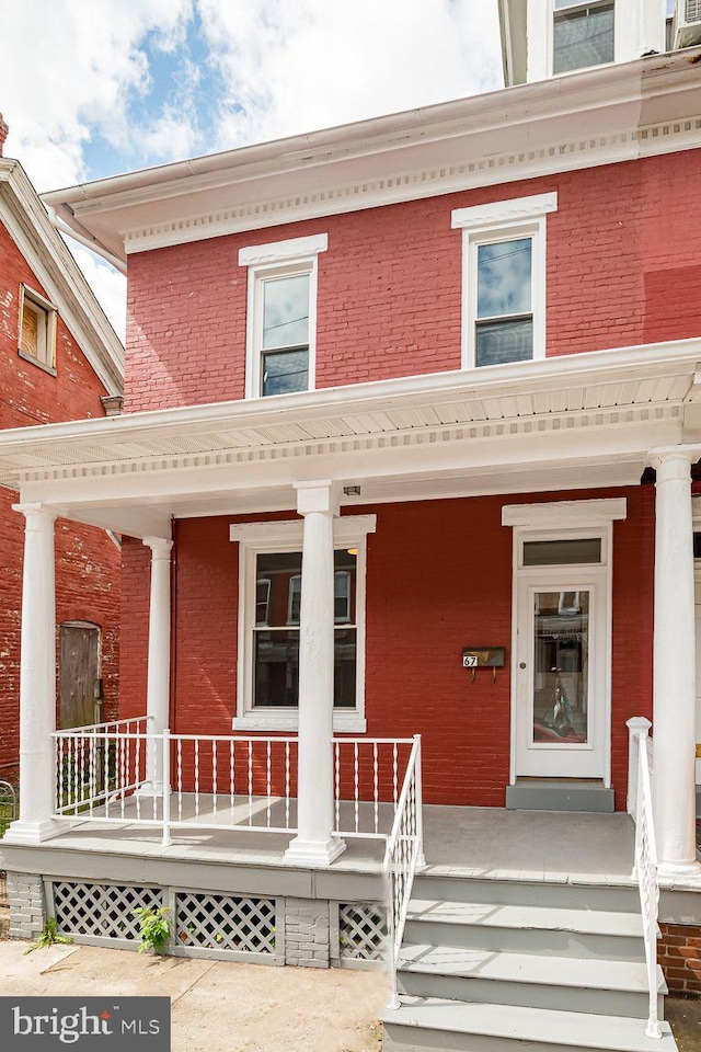 entrance to property featuring a porch