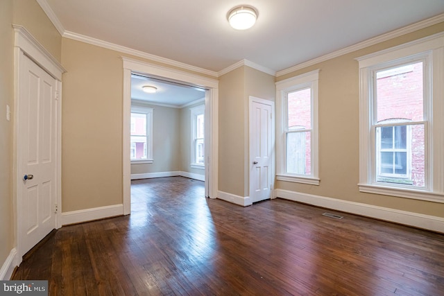 spare room featuring crown molding and dark wood-type flooring