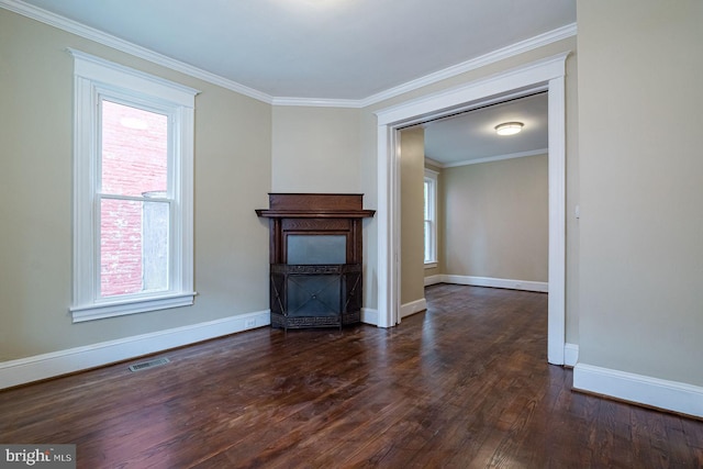 unfurnished living room with dark hardwood / wood-style floors, ornamental molding, and a wealth of natural light