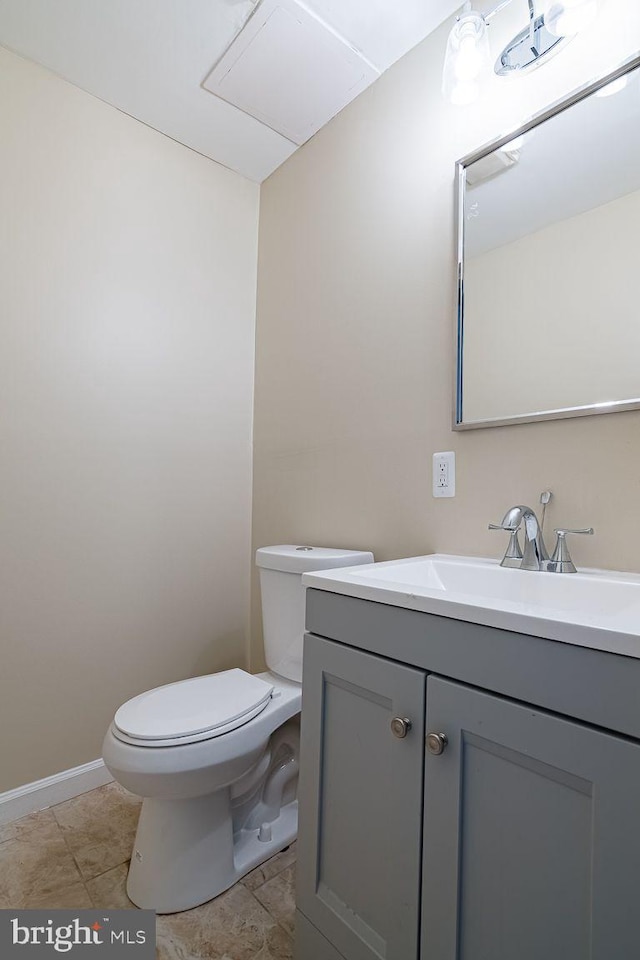 bathroom with tile patterned flooring, vanity, and toilet