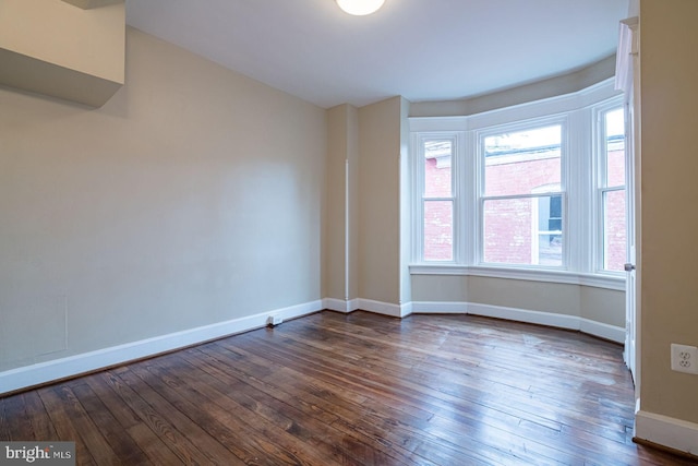 empty room with dark hardwood / wood-style floors