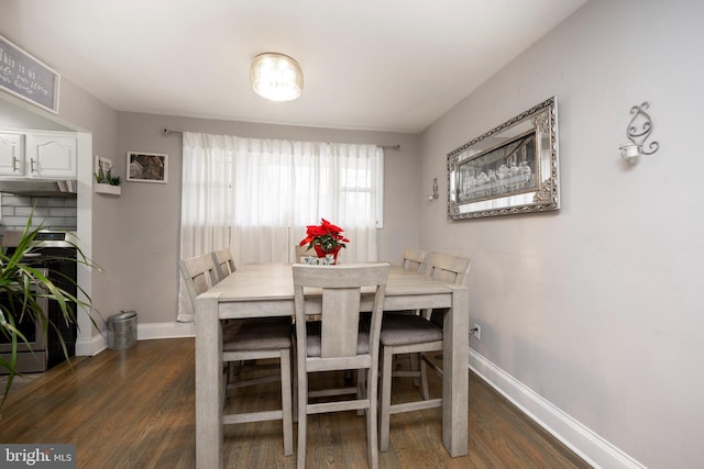 dining space with dark wood-type flooring