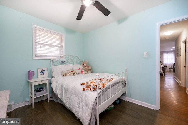 bedroom featuring ceiling fan and dark hardwood / wood-style flooring