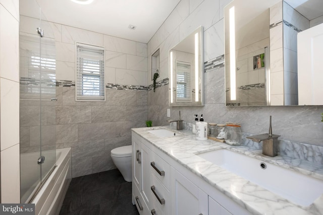 full bathroom featuring backsplash, vanity, tile walls, toilet, and tiled shower / bath