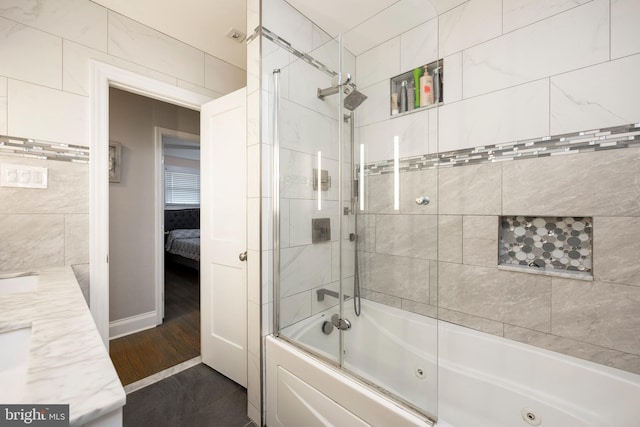 bathroom featuring tiled shower / bath combo, wood-type flooring, and vanity