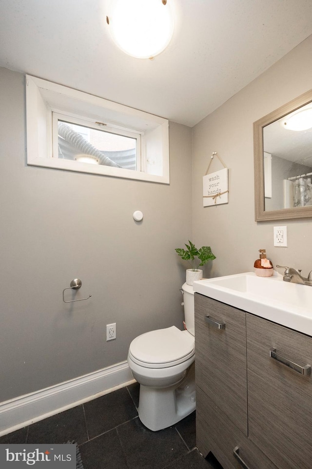 bathroom with tile patterned floors, vanity, and toilet