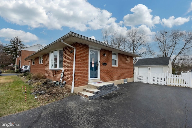 view of front of house with a garage and an outdoor structure